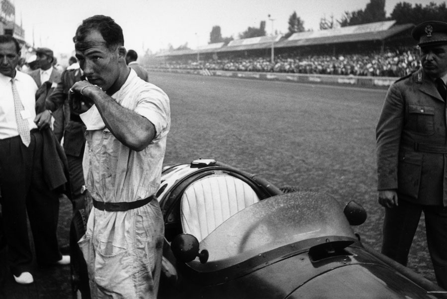 Stirling Moss stands by his car ahead of the race