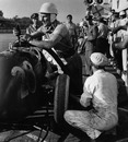 Stirling Moss fills his car with fuel during a pit stop