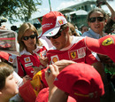 Fernando Alonso is mobbed by fans as he arrives at the Autodromo Nazionale di Monza