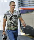 A casually dressed Michael Schumacher arrives at the circuit on Thursday