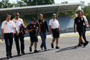Vitaly Petrov walks the circuit with some Renault engineers