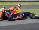 Mark Webber's car is pushed by marshals in FP3