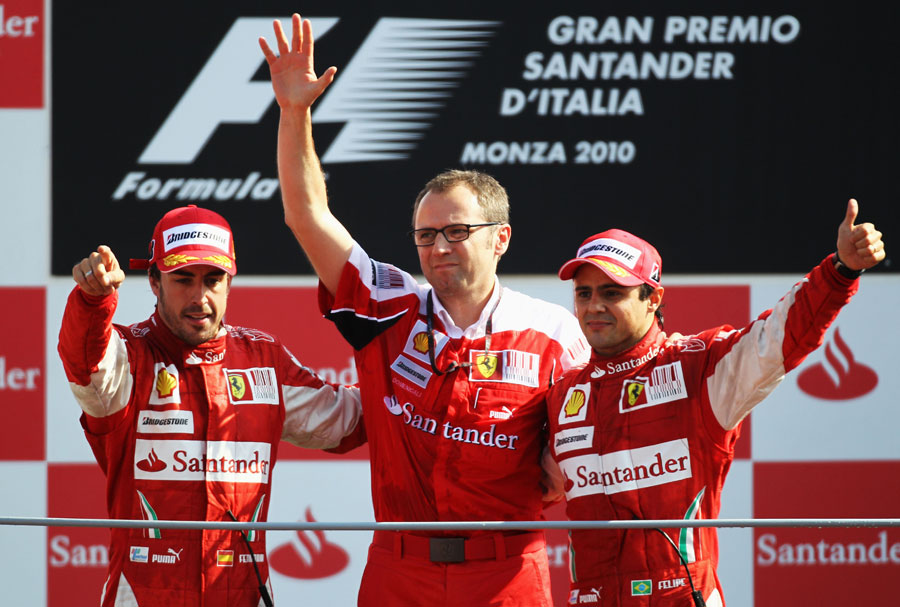 Fernando Alonso and Felipe Massa celebrate with Stefano Domenicali on the podium