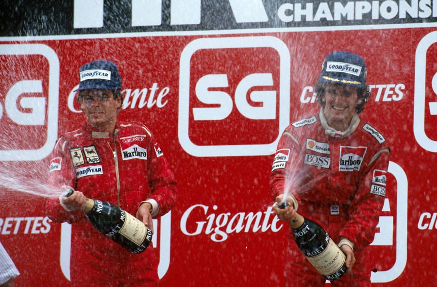 Alain Prost celebrates a win, with Gerhard Berger finishing second