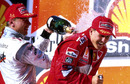 Mika Hakkinen sprays Michael Schumacher with champagne