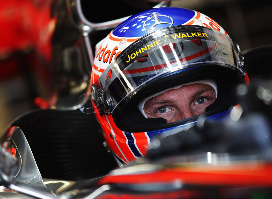 Jenson Button prepares to leave the McLaren garage
