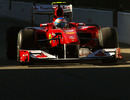 Fernando Alonso cruises down the pit lane