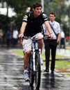 Mark Webber cycles to the paddock