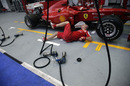 A mechanic works on the Ferrari