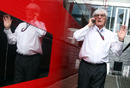 Bernie Ecclestone takes a phone call in the paddock