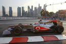 Jenson Button on track as the sun sets over the Singapore skyline