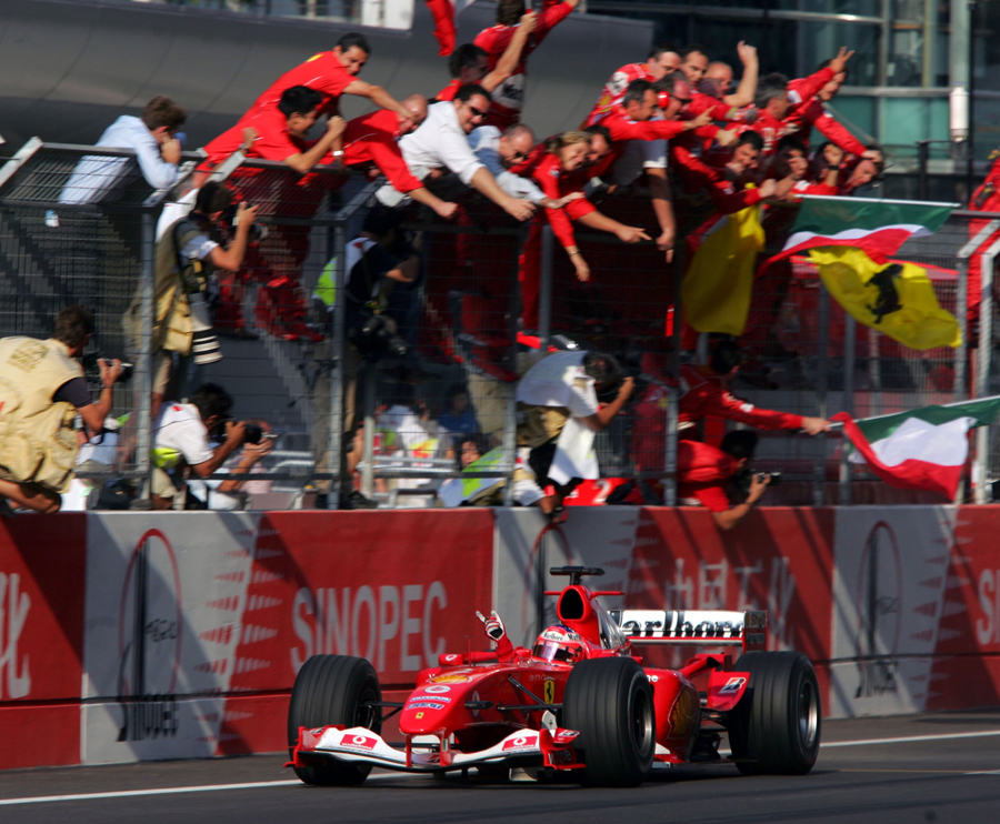 Rubens Barrichello takes the plaudits from the pit wall after winning the debut Chinese Grand Prix