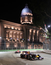 Sebastian Vettel passes in front of city hall