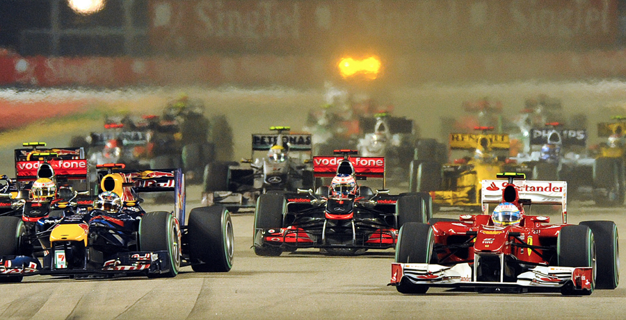 Fernando Alonso leads Sebastian Vettel away at the start