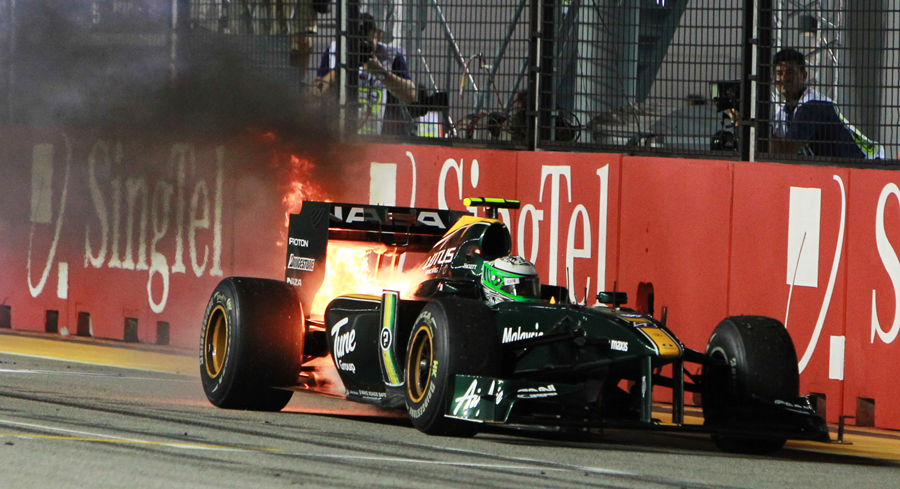Heikki Kovalainen's Lotus blazes as he slowly brings it to a halt 