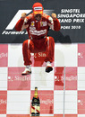 Fernando Alonso leaps in the air to celebrate his victory