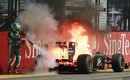 Heikki Kovalainen tries to put out an engine fire