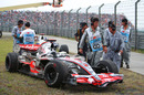 Lewis Hamilton's McLaren sits parked in the gravel