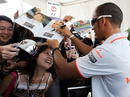 Lewis Hamilton signs autographs for fans at Suzuka