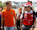 Michael Schumacher and Felipe Massa chat as they arrive at Suzuka