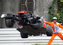 Lewis Hamilton's wrecked McLaren is lifted away