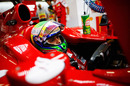 Felipe Massa keeps an eye on the timing screens in the Ferrari garage