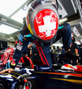 Sebastien Buemi clambers into his Toro Rosso