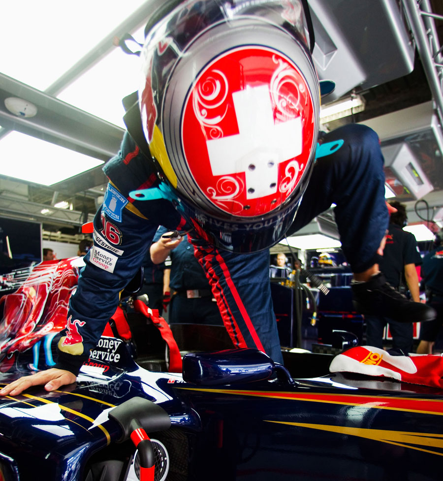 Sebastien Buemi clambers into his Toro Rosso