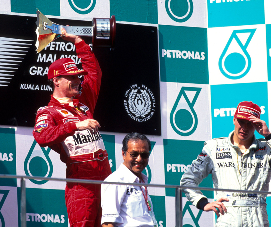 Eddie Irvine celebrates his win in Malaysia, shortly before being disqualified
