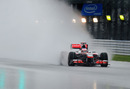 Spray flies from the back of Jenson Button's McLaren