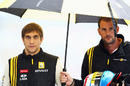 Vitaly Petrov takes shelter from the pouring rain