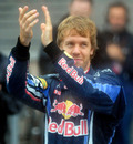 Sebastian Vettel applauds the fans after a difficult day