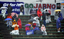 Fans brave appalling conditions in the hope of seeing some action