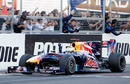 Sebastian Vettel takes the plaudits from the pit wall as he crosses the line