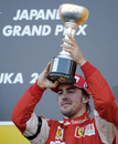 Fernando Alonso celebrates his third place