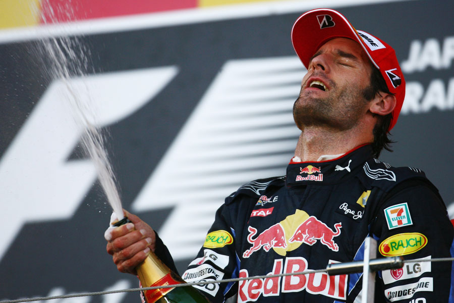 Mark Webber celebrates on the podium