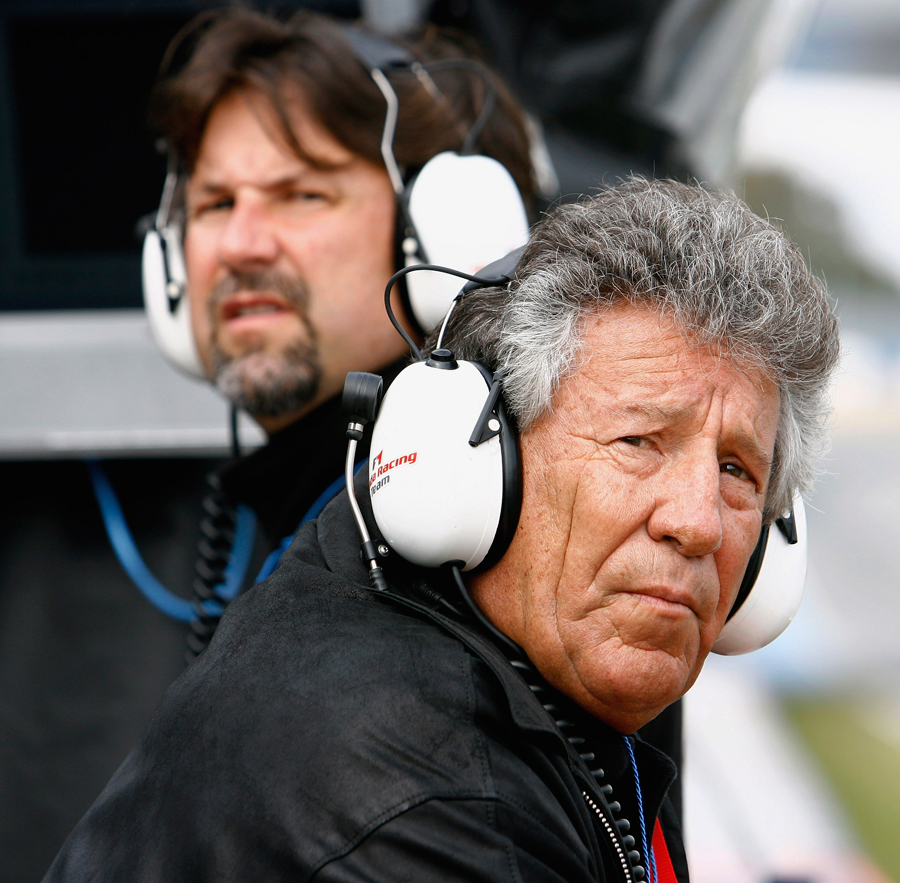 Mario Andretti and his son Michael Andretti look on as Marco Andretti, the son Michael, tests for Honda