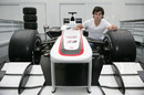 Sergio Perez gets a close-up look at the Sauber on a factory visit