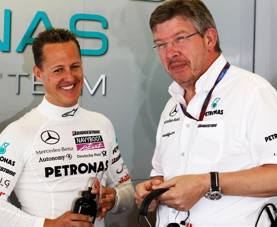 Michael Schumacher shares a joke with Ross Brawn