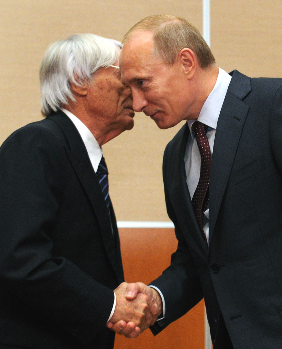 Bernie Ecclestone and Russian Prime Minister Vladimir Putin shake hands