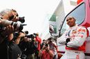 Lewis Hamilton poses for photographers