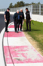 The FIA's Herbie Blash and Charlie Whiting inspect the final corner 