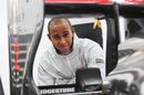 Lewis Hamilton inspects the rear of his McLaren
