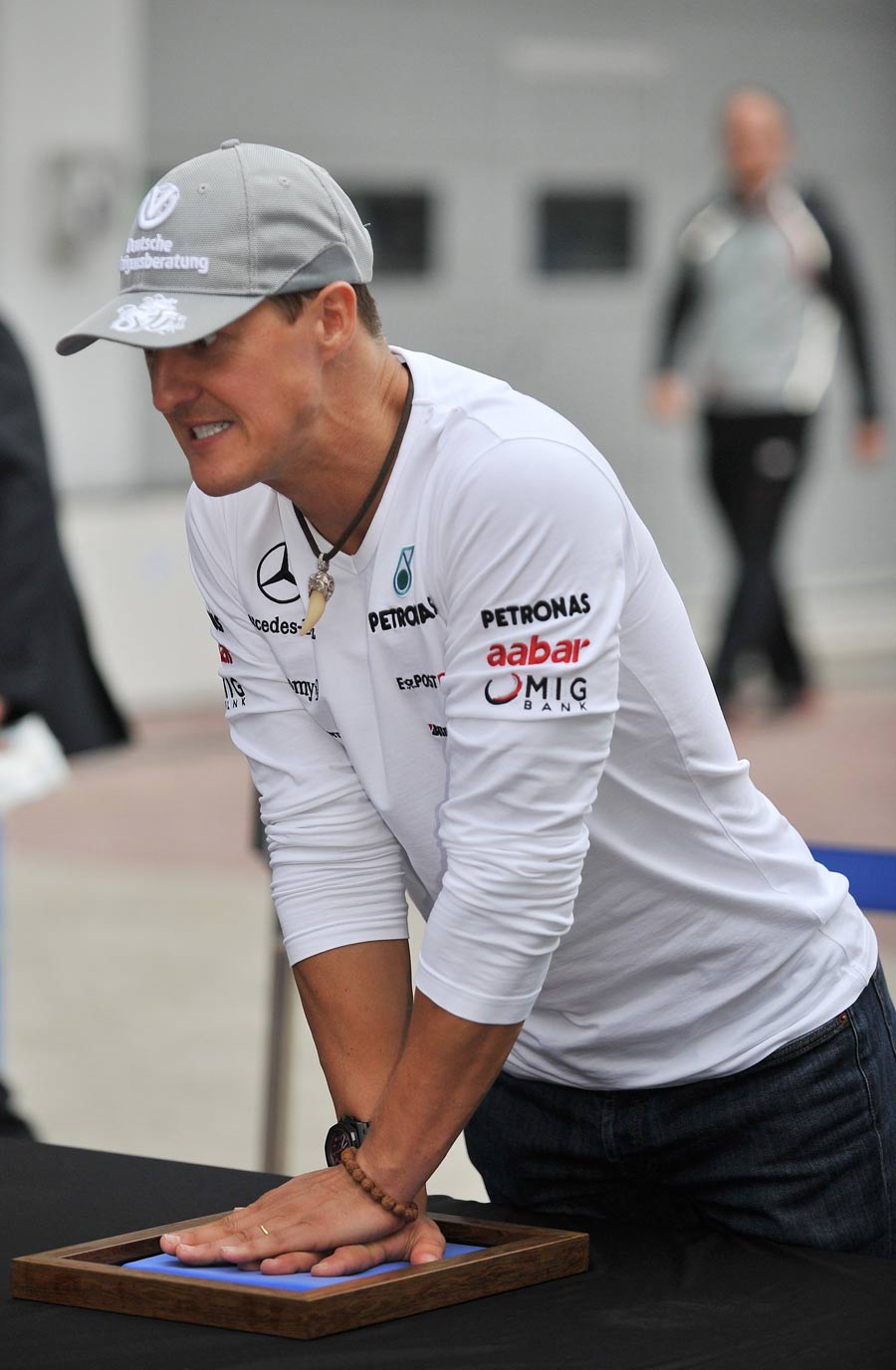 Michael Schumacher presses his hand into a mould for a permanent exhibition to recognize the first participants of the Korean Grand Prix 