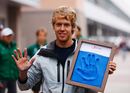 Sebastian Vettel poses with a mould of his hand to recognize the first participants of the Korean Grand Prix 