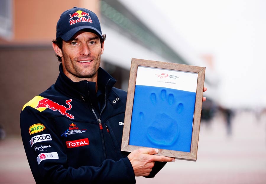 Mark Webber poses with a mould of his hand to recognize the first participants of the Korean Grand Prix 