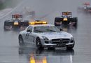 The leaders follow the safety car around in wet conditions