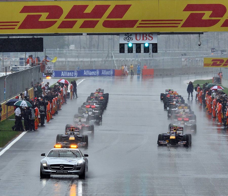 The grid assembles behind the safety car on a wet Yeongam circuit