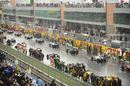 Cars line up on a wet grid
