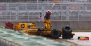 Vitaly Petrov climbs out of his wrecked Renault